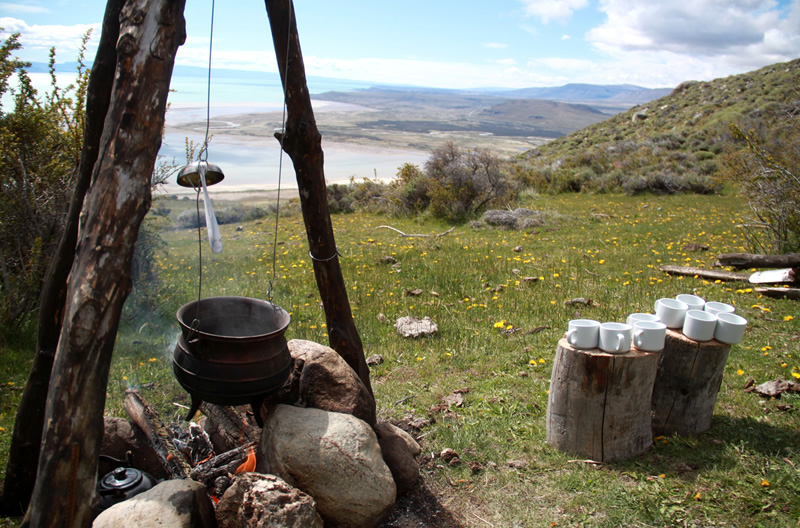 Special services groups including natural lookouts snack on the hill. Lake Argentino.